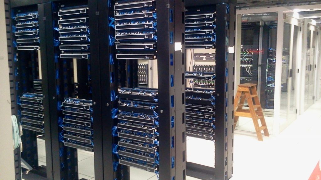 Rows of server racks in a machine room, receding into the distance